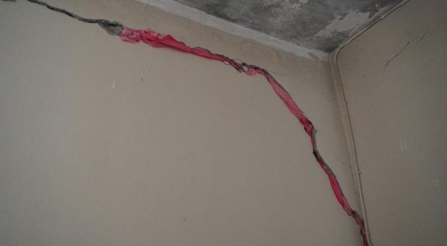 Depremle oluşan çatlakları bez parçaları ile kapattı