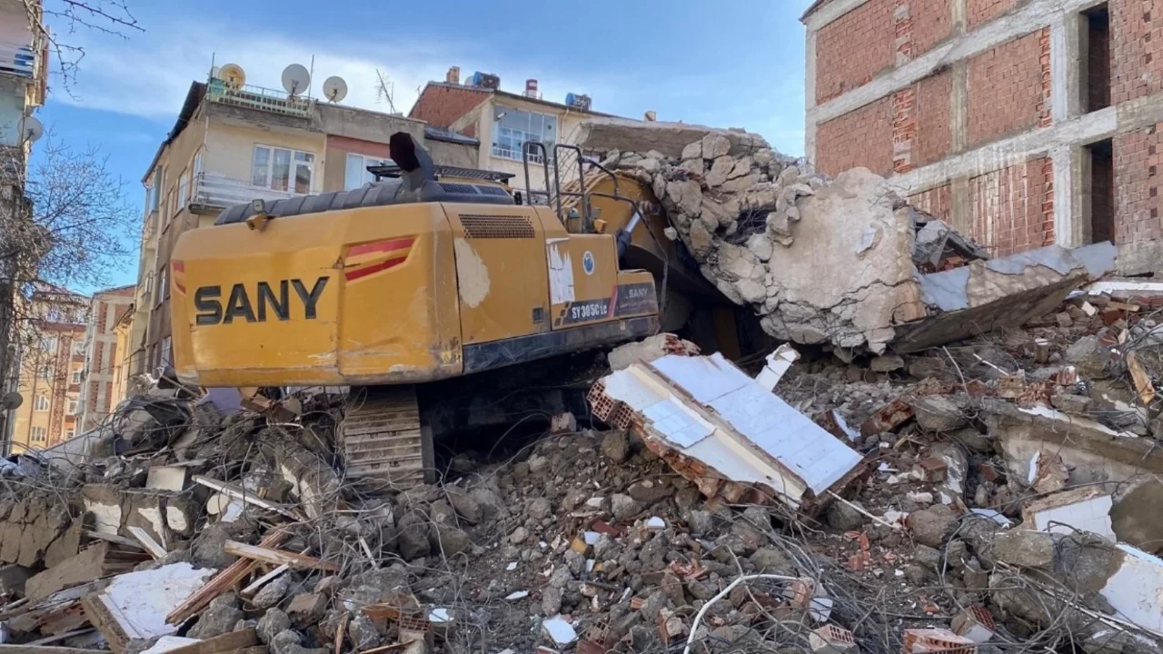 Elazığ'da ağır hasarlı binanın enkazı iş makinesinin üstüne yıkıldı